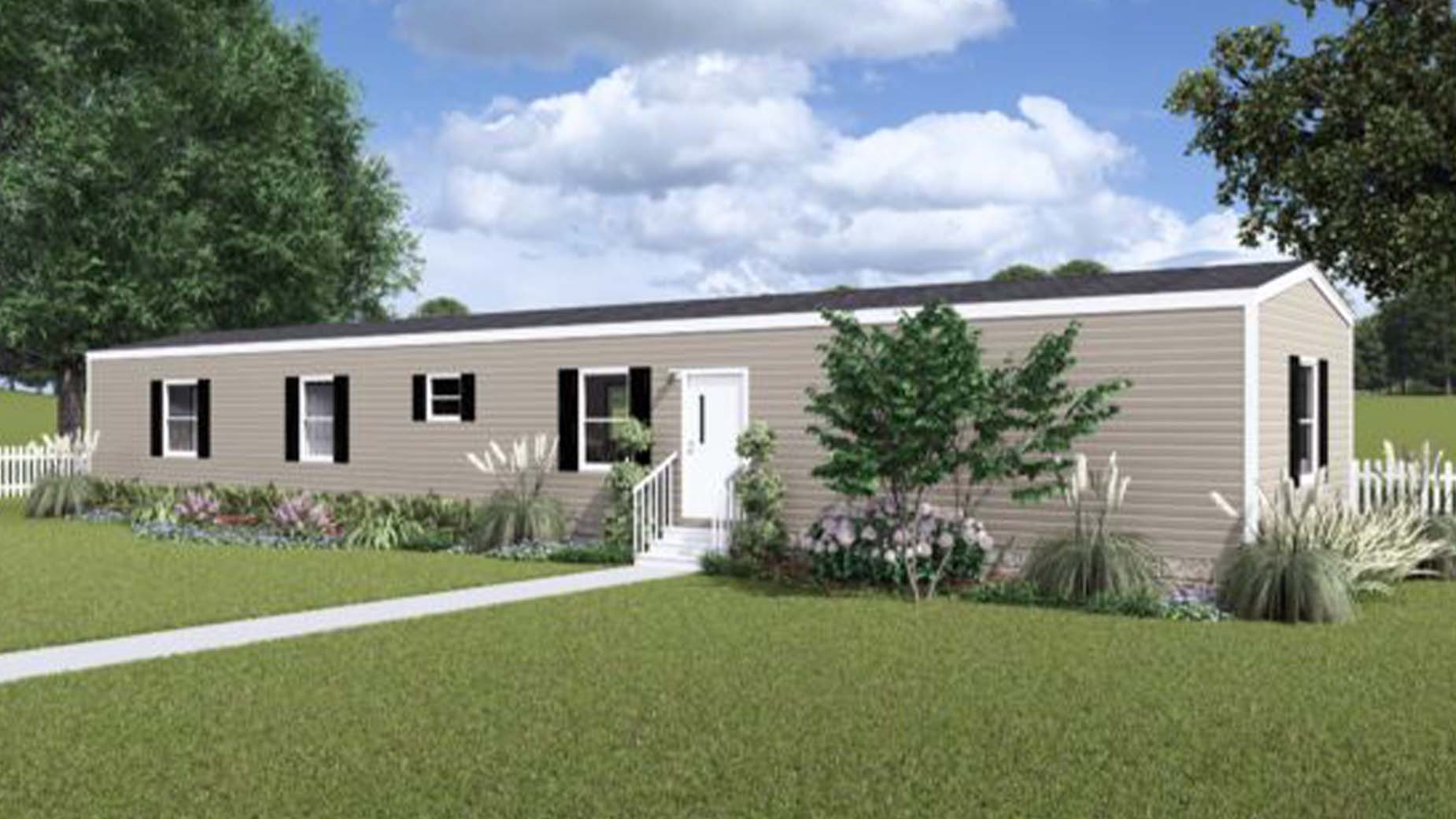 Tan-colored manufactured home with white trim, surrounded by greenery and a white picket fence under a blue sky.