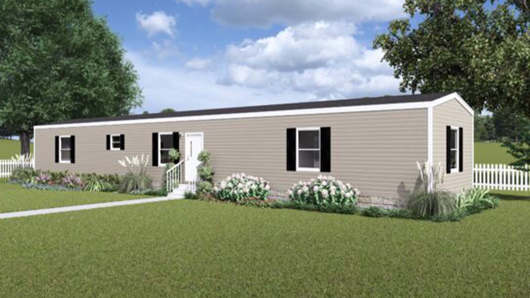 A beige manufactured home with black shutters, white trim, a small porch, and a white fence sits in a grassy yard.